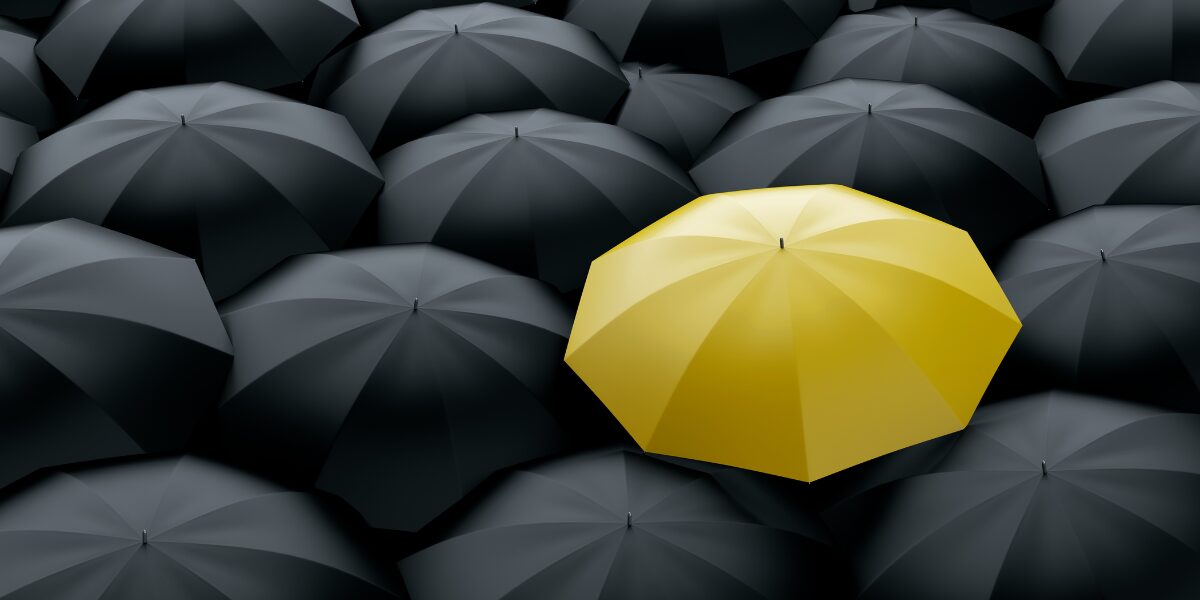 Black umbrellas with a yellow umbrella in the center.