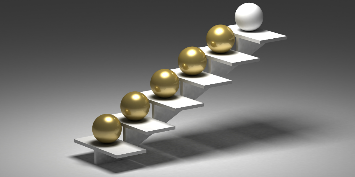 An image with gold and white balls sitting on stairs.