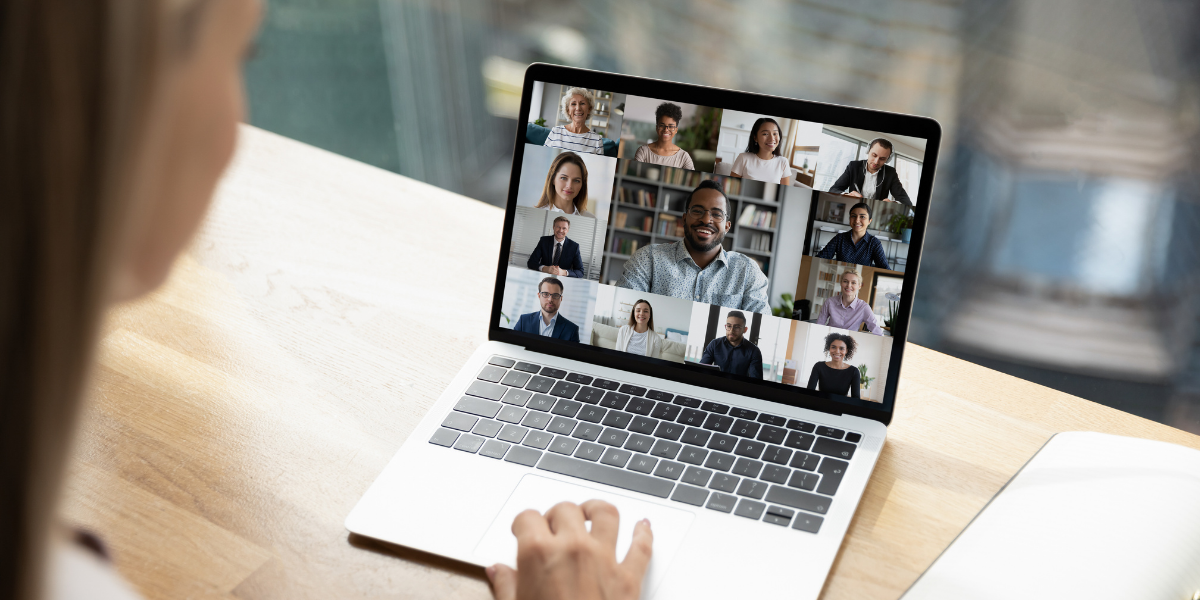 A person sitting at a desk participating in a virtual meeting.