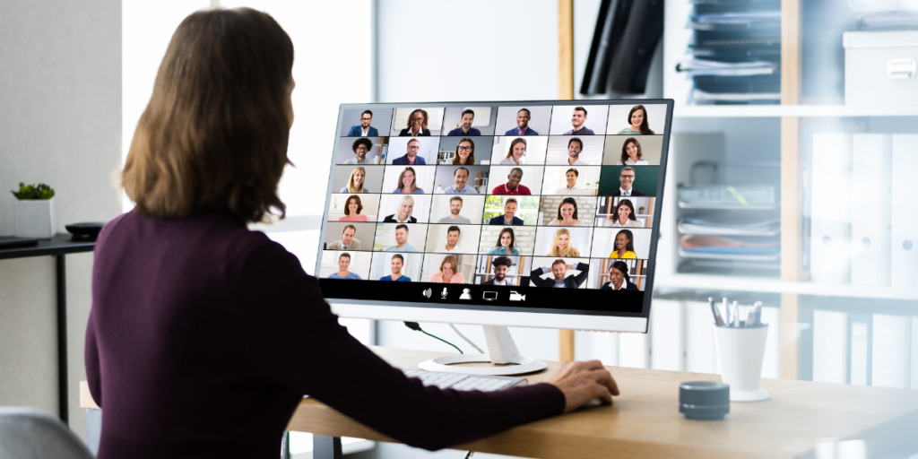 A woman sitting at her desk participating in a virtual meeting.