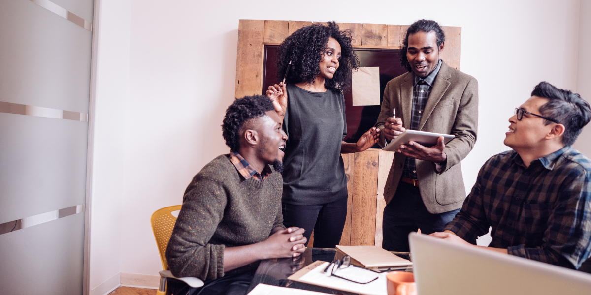 A group of people conversing and collaborating on a document.