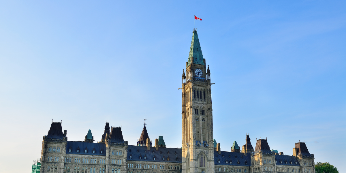 Parliament of Canada buildings in Ottawa with a bright blue sky in behind.