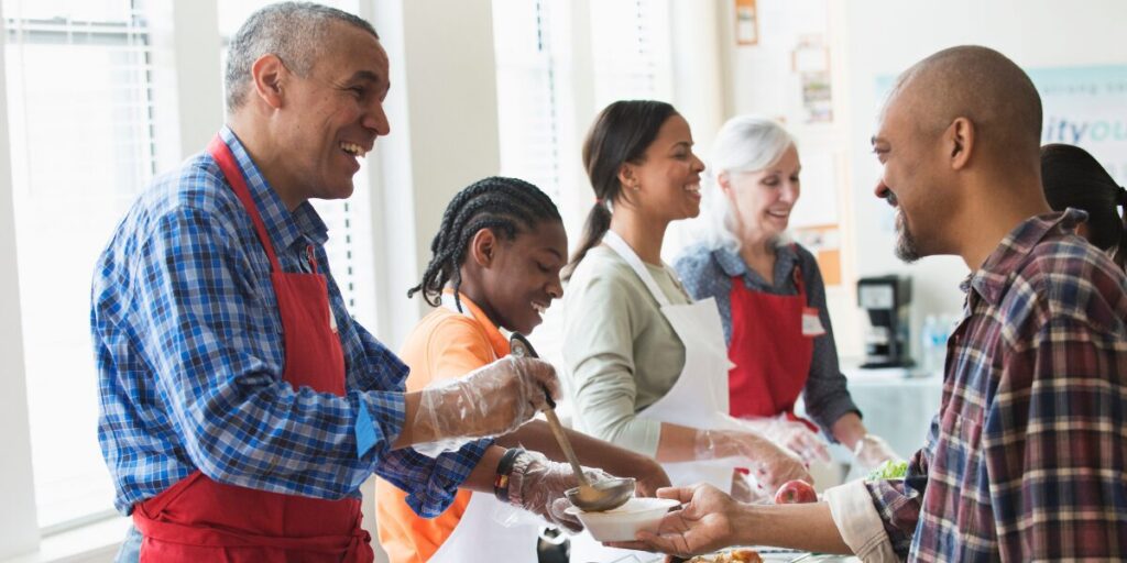 A group of people are volunteering at a food bank and serving soup.